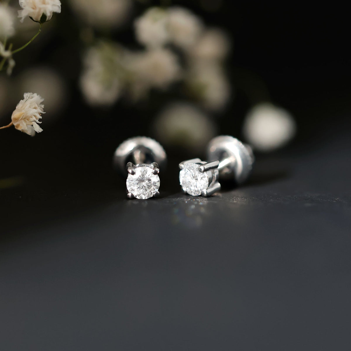 Sterling silver moissanite half carat stud earrings from Rosec Jewels, featuring sparkling gemstones and classic design.
