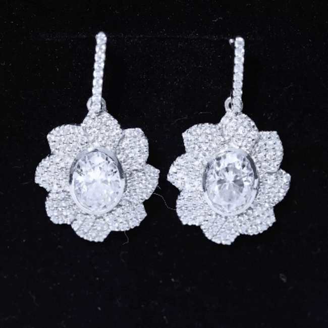 Bezel set 2.5 carat oval moissanite flower drop earrings by Rosec Jewels featuring sparkling gemstone accents and elegant design.