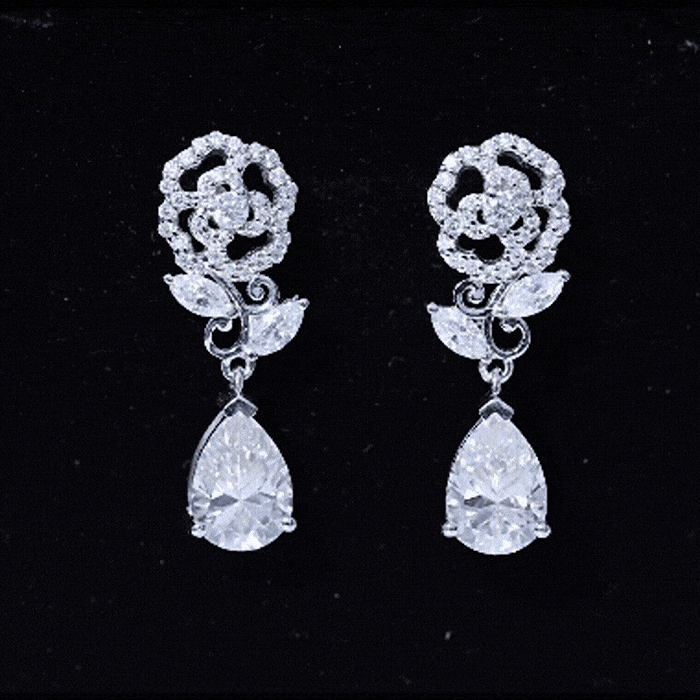 Pear-shaped moissanite dangle earrings with rose flower design, crafted by Rosec Jewels for wedding or special occasions.