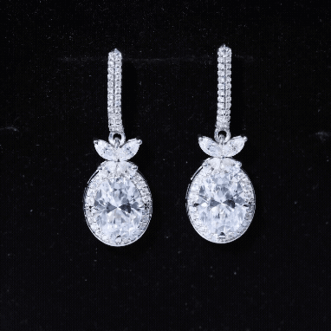 Rosec Jewels 7x9 mm oval moissanite drop earrings with screw back fastening, elegant jewelry for special occasions.