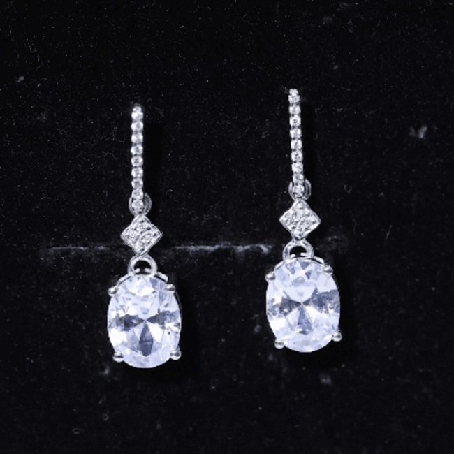 Oval-shaped 4-carat moissanite dangle earrings for women by Rosec Jewels, featuring sparkling white gemstones and elegant design.