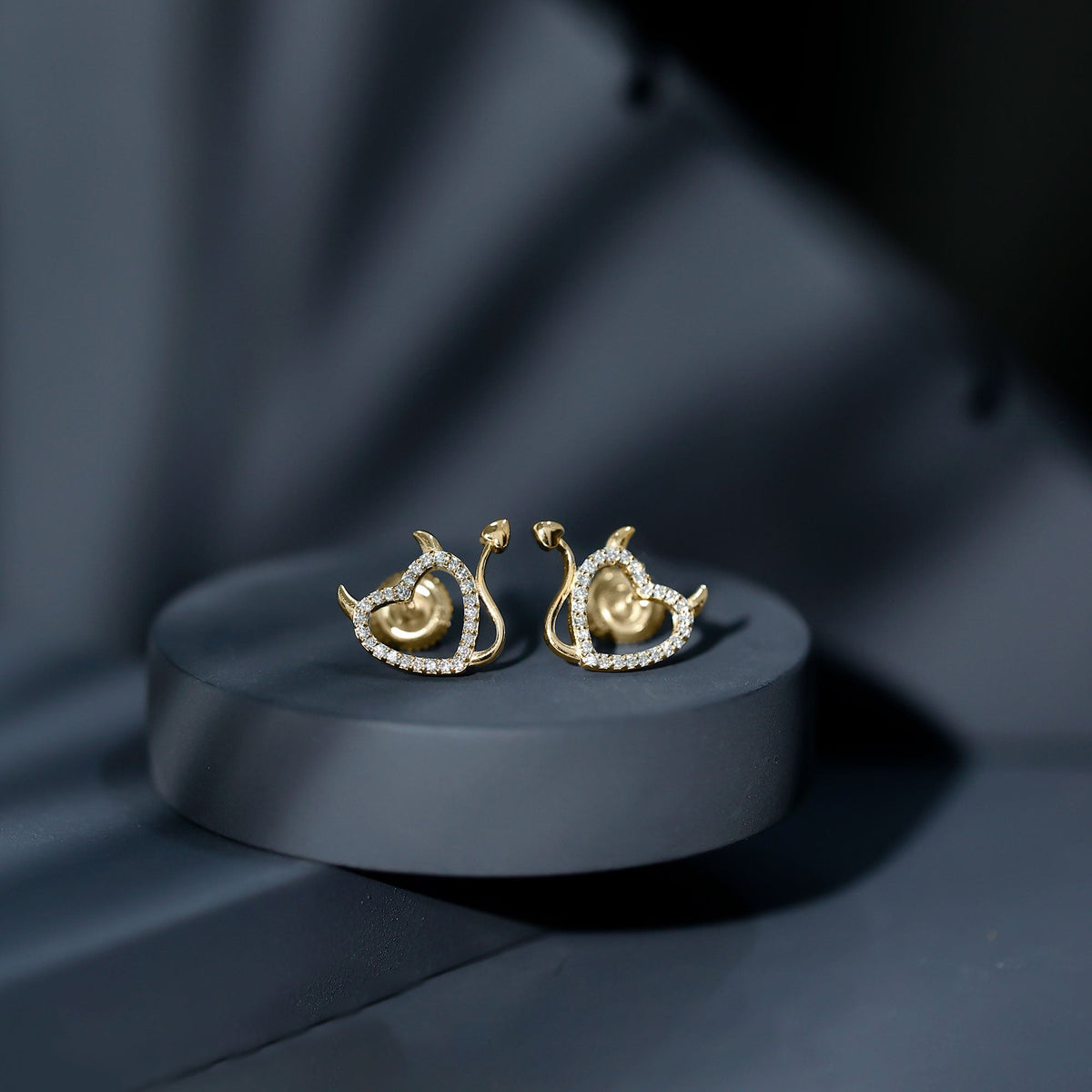 Round diamond devil heart earrings by Rosec Jewels featuring sparkling diamonds and intricate heart-shaped design.