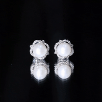 Rosec Jewels cultured pearl stud earrings with diamond accents, showcasing elegant white pearls and sparkling gemstones.