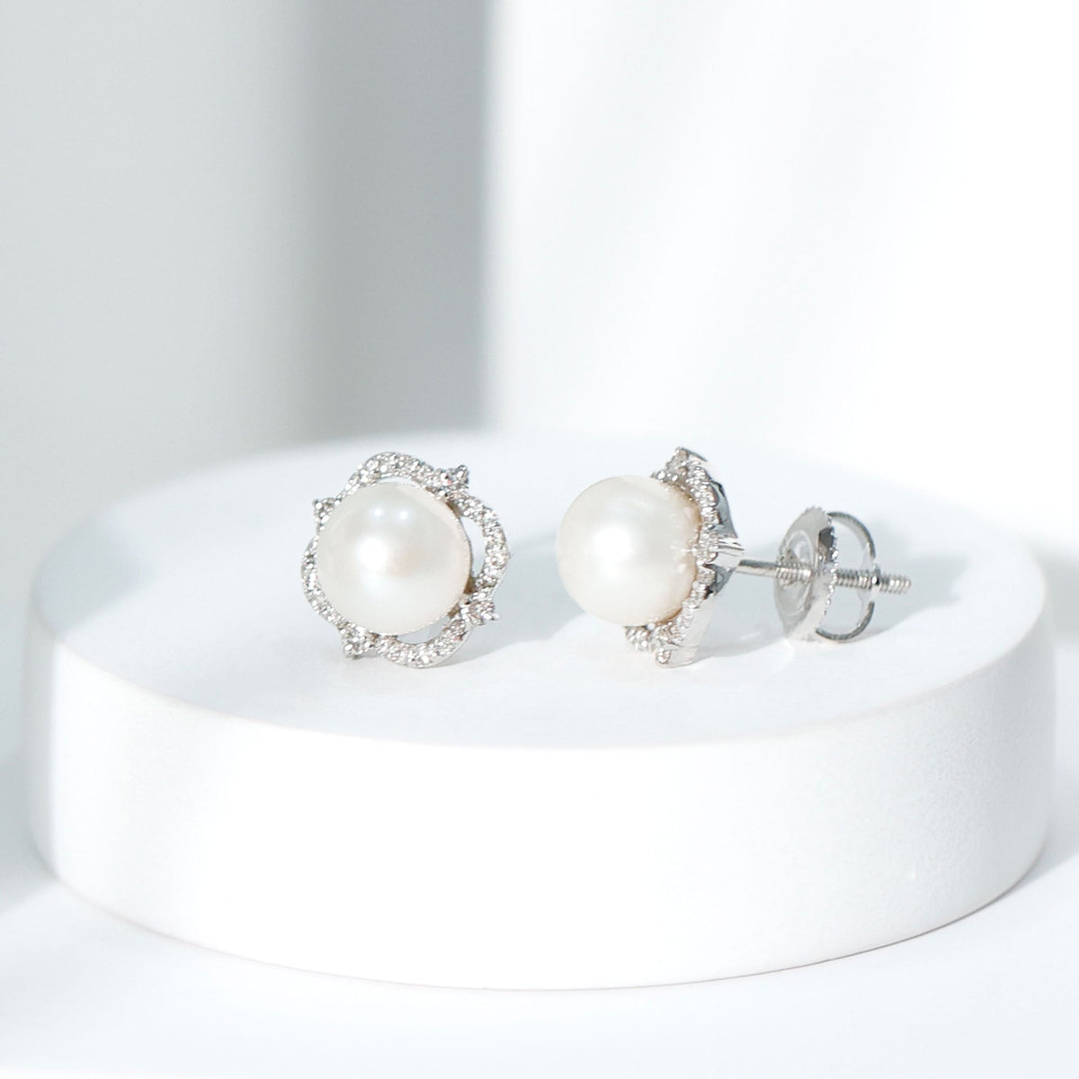 Cultured pearl stud earrings with diamond accents from Rosec Jewels showing elegant pearl and sparkling diamonds.