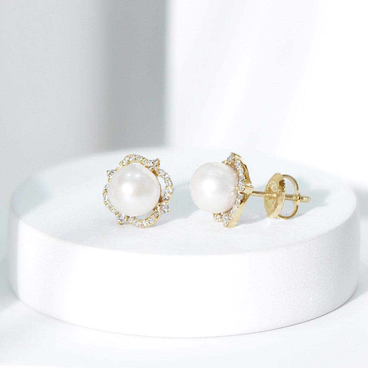 Rosec Jewels cultured pearl stud earrings with diamonds, showcasing elegant pearl and sparkling diamond accents on classic earrings.