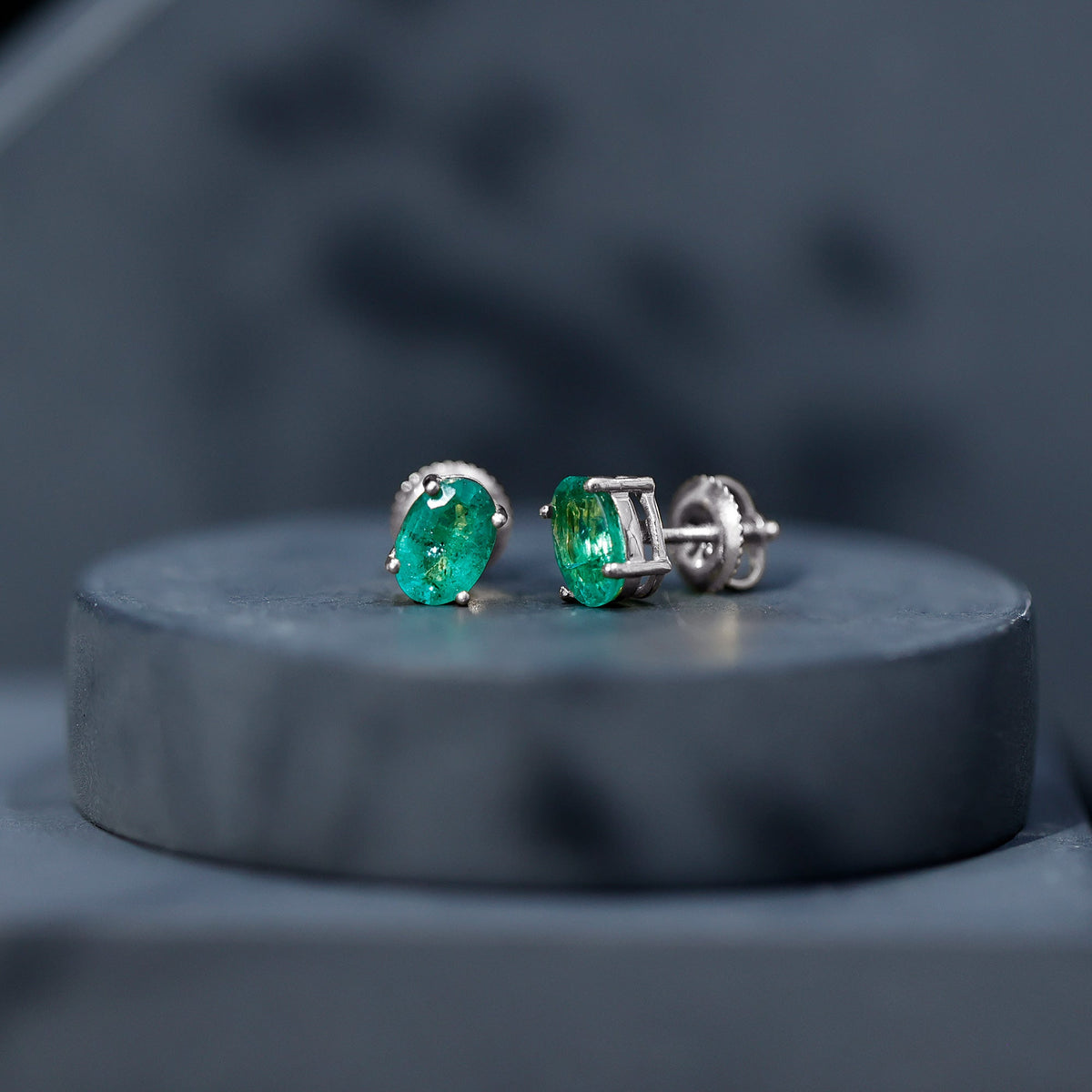 Oval shape emerald stud earrings for women with 1.43 carats, crafted by Rosec Jewels, featuring vibrant green gemstones.