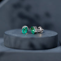 Oval shape emerald stud earrings for women with 1.43 carats, crafted by Rosec Jewels, featuring vibrant green gemstones.