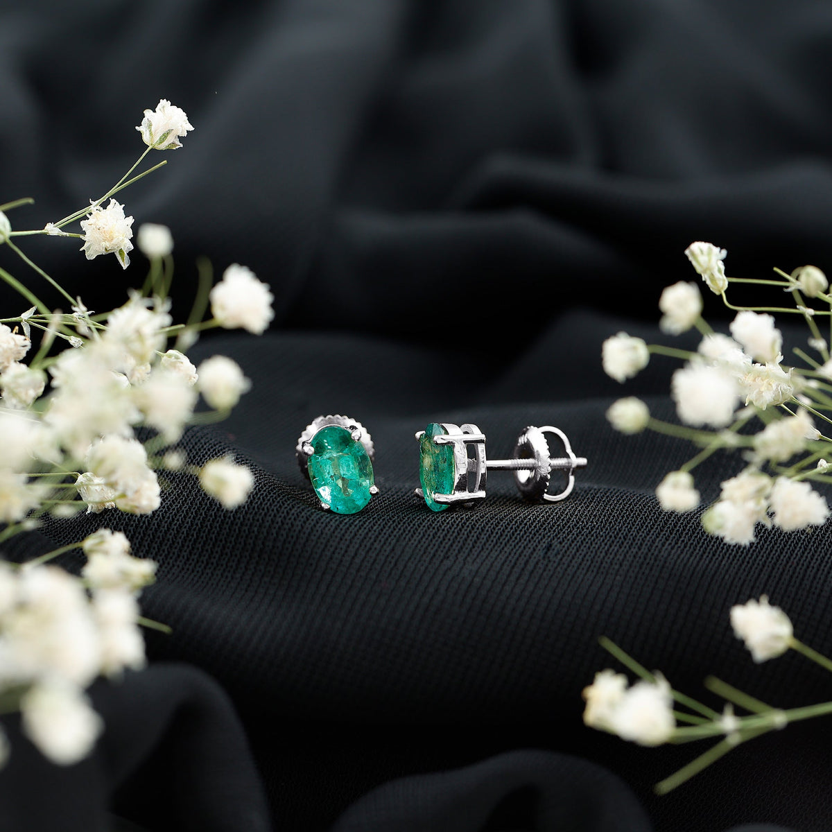 Oval 1.43 carat emerald stud earrings for women by Rosec Jewels, showcasing sparkling green gemstone and silver setting.