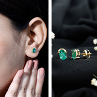 Oval shape emerald stud earrings for women by Rosec Jewels, featuring 1.43 carats of vibrant green gemstones.