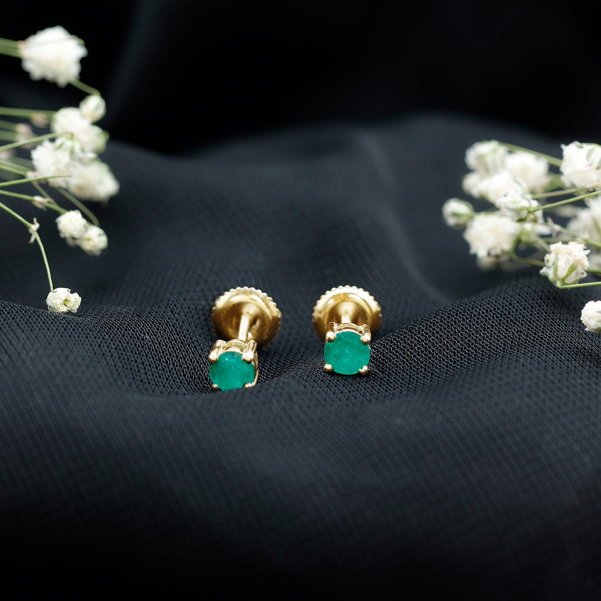 Round cut 5 mm real emerald stud earrings by Rosec Jewels, showcasing sparkling green gemstones set in classic earrings.