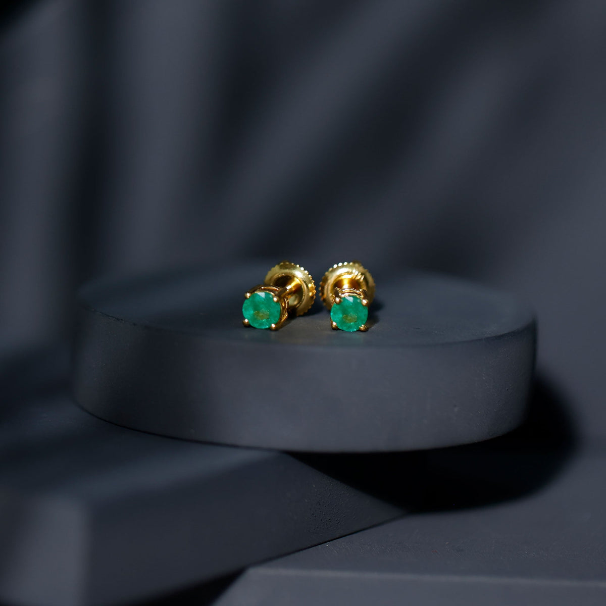 Round cut 5mm real emerald stud earrings by Rosec Jewels featuring vibrant green gemstones set in classic earrings.