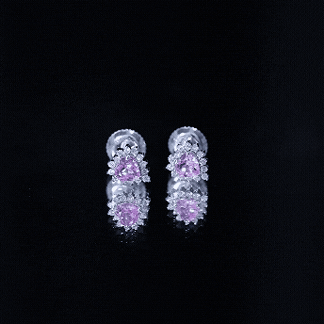 Lab grown pink sapphire heart stud earrings with diamond halo, featuring 0.6 carat pink sapphires and sparkling diamonds.