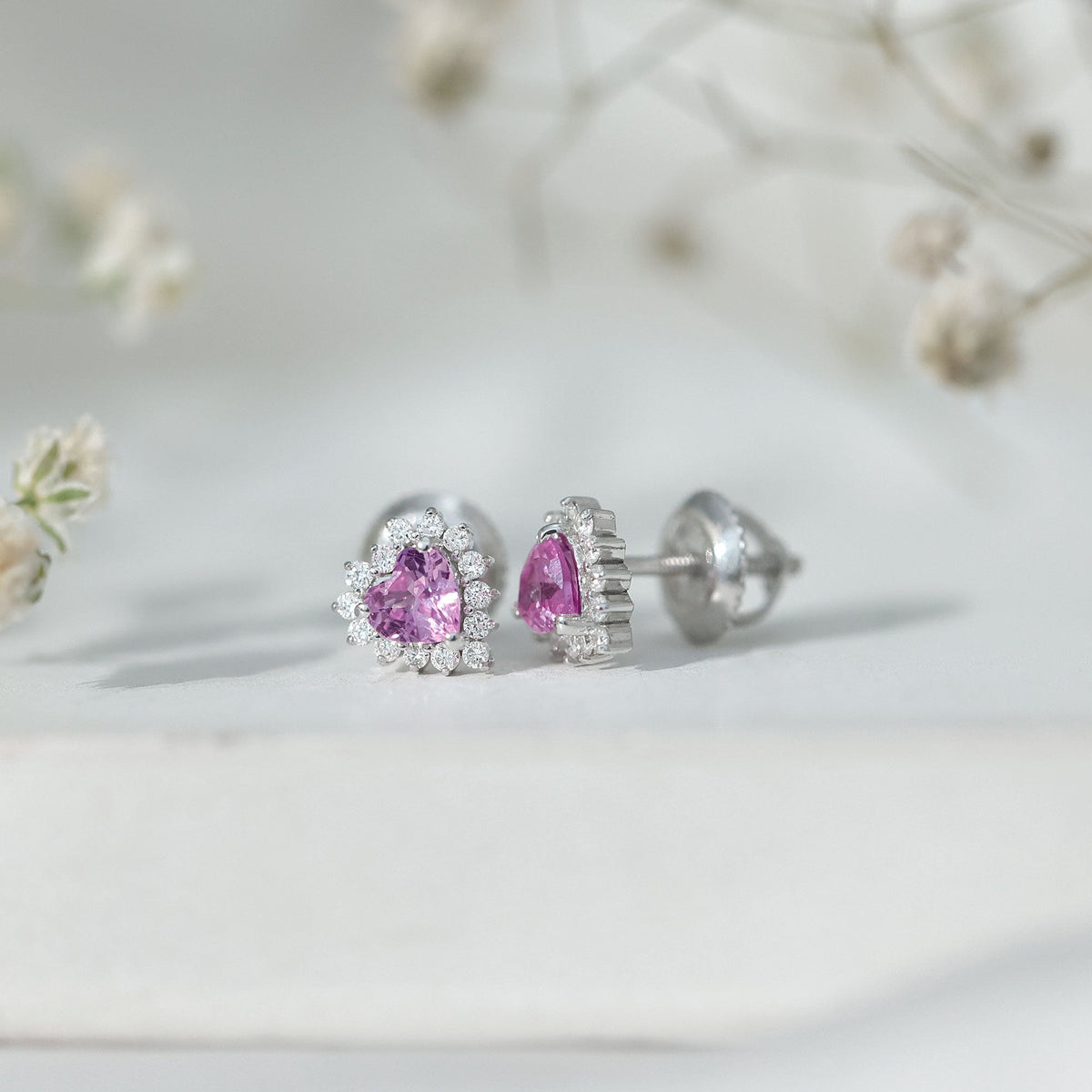 Rosec Jewels 0.6 carat lab-grown pink sapphire heart stud earrings with diamond halo, showcasing shimmering pink sapphires and sparkling diamonds.