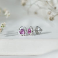 Rosec Jewels 0.6 carat lab-grown pink sapphire heart stud earrings with diamond halo, showcasing shimmering pink sapphires and sparkling diamonds.