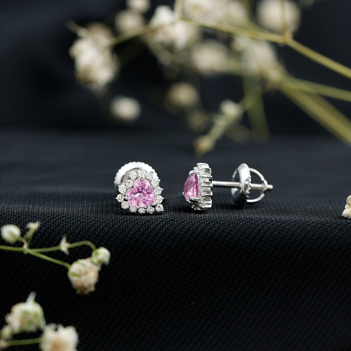 Lab-grown pink sapphire heart stud earrings with diamond halo from Rosec Jewels, showcasing pink sapphires and sparkling diamonds.