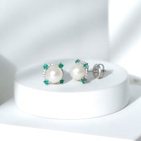 Freshwater pearl bridal stud earrings with emerald accents by Rosec Jewels, showcasing elegant pearl and gemstone details.