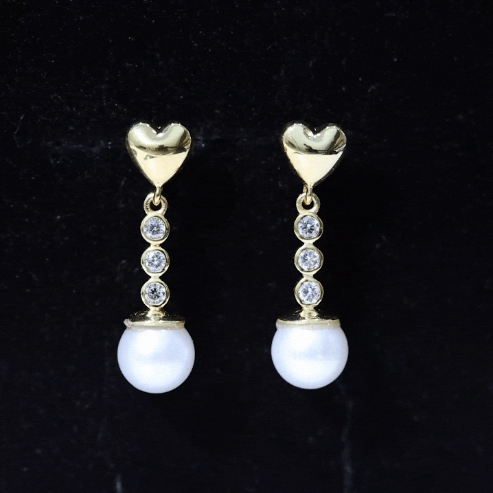 Genuine 6-carat freshwater pearl and diamond dangle earrings by Rosec Jewels featuring elegant yellow accents.