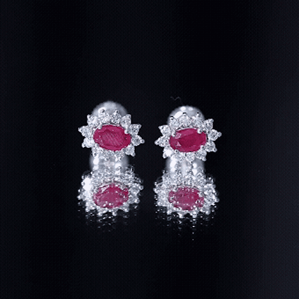 Genuine oval cut ruby and diamond halo stud earrings by Rosec Jewels featuring yellow gold settings.