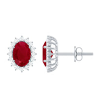 Genuine oval cut ruby and diamond halo stud earrings by Rosec Jewels featuring sparkling gemstones and elegant design.