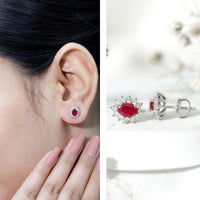 Genuine oval cut ruby and diamond halo stud earrings by Rosec Jewels, featuring vibrant red rubies with sparkling diamond accents.