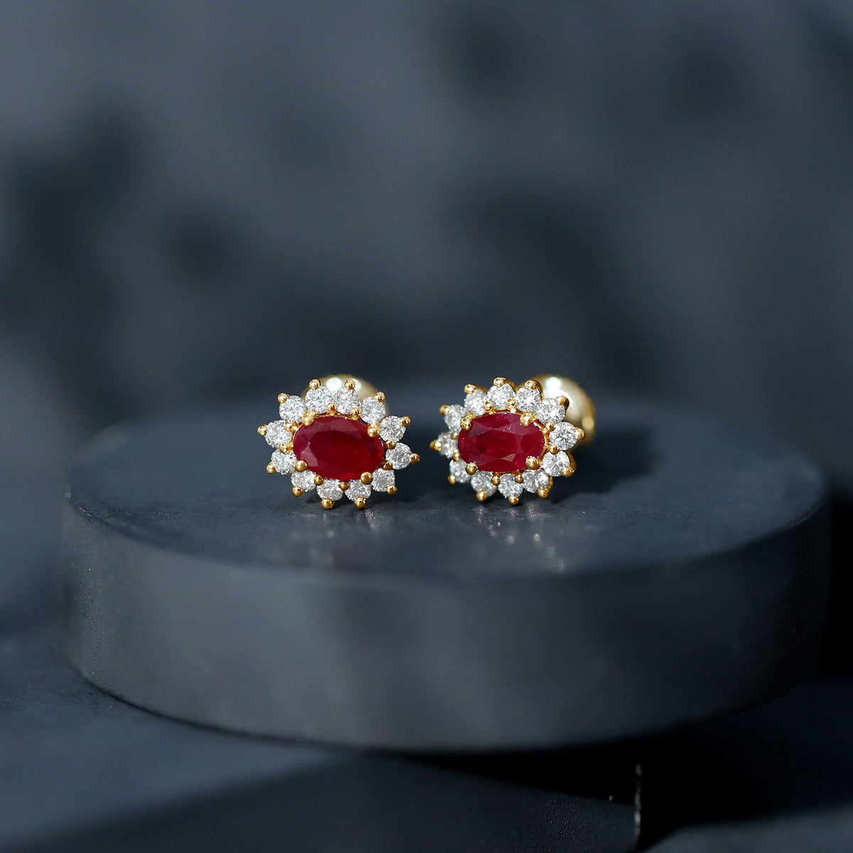 Genuine oval cut ruby and diamond halo stud earrings by Rosec Jewels featuring sparkling gemstones and elegant design