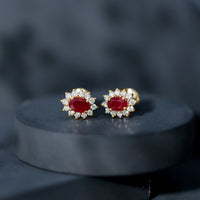 Genuine oval cut ruby and diamond halo stud earrings by Rosec Jewels featuring sparkling gemstones and elegant design