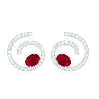Oval cut ruby and diamond swirl stud earrings by Rosec Jewels, featuring sparkling gemstones in a elegant earring design.