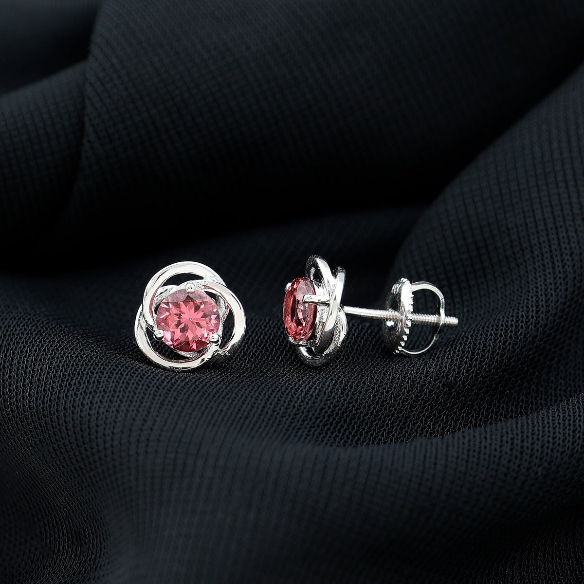 Rosec Jewels 0.9 Carat pink tourmaline swirl stud earrings featuring solitaire design in a close-up image.