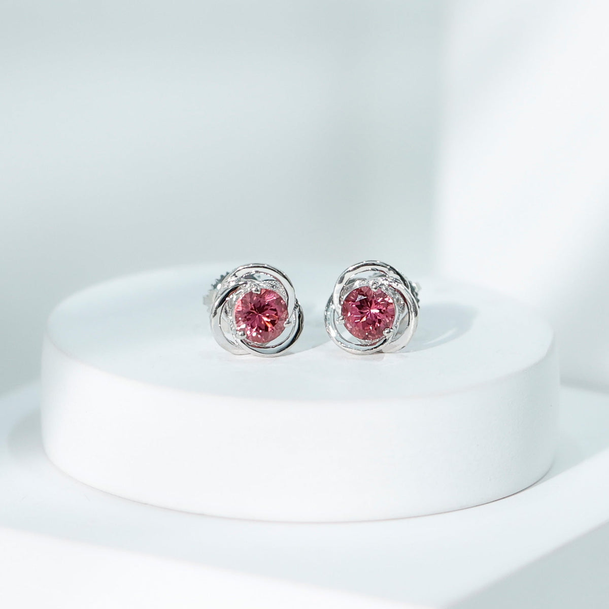 Pink tourmaline swirl stud earrings featuring 0.9 carats from Rosec Jewels, showcasing elegant jewelry design and sterling silver posts.