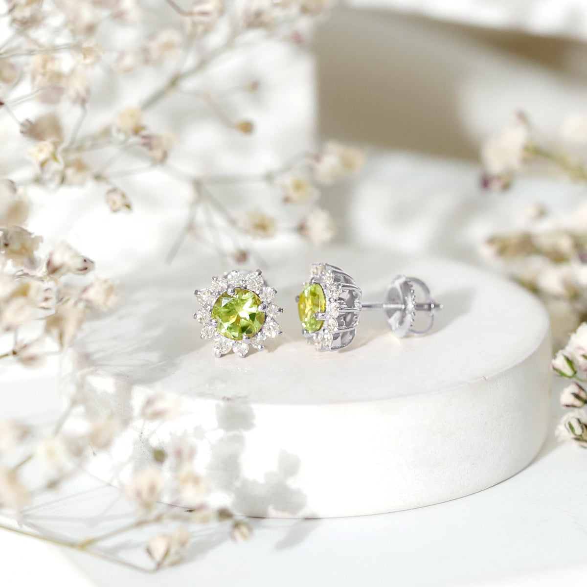 Rosec Jewels 1 Carat Peridot stud earrings with diamond halo, featuring vibrant green gemstones and sparkling diamond accents.