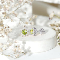 Rosec Jewels 1 Carat Peridot stud earrings with diamond halo, featuring vibrant green gemstones and sparkling diamond accents.
