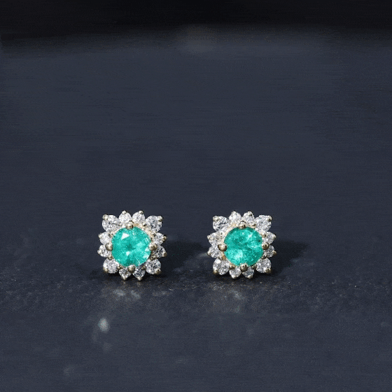 Real emerald stud earrings with diamond halo from Rosec Jewels, showcasing elegant green emeralds surrounded by sparkling diamonds.
