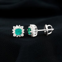Real emerald stud earrings with diamond halo featuring vibrant green emeralds and sparkling diamonds in Rosec Jewels design.