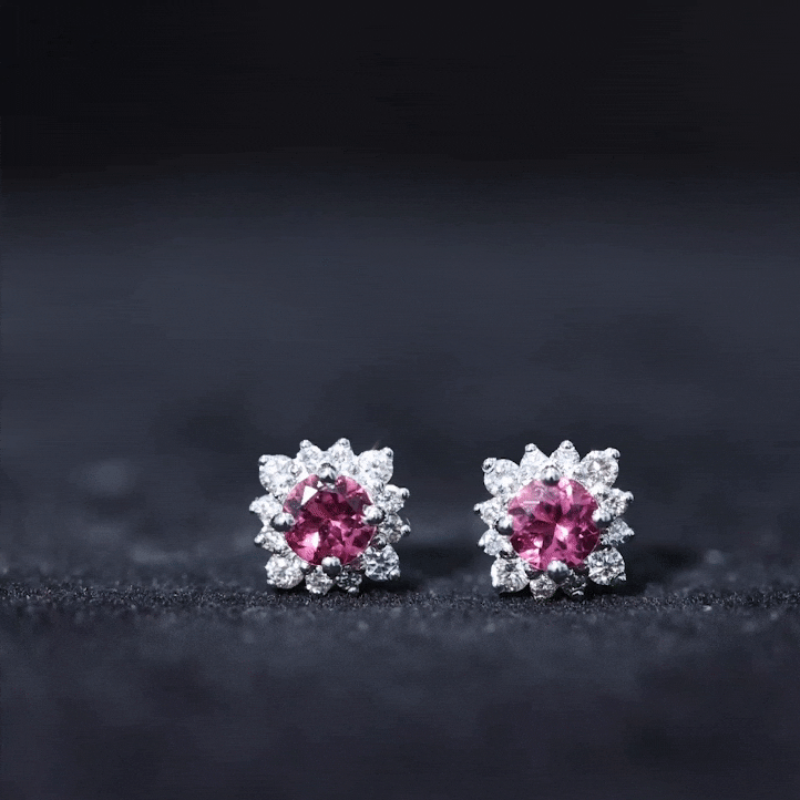 Round pink tourmaline stud earrings with a diamond halo, crafted by Rosec Jewels, showcasing elegant jewelry design.
