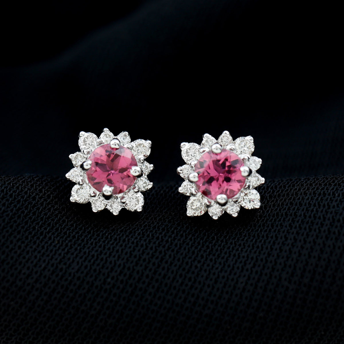 Round pink tourmaline stud earrings with diamond halo by Rosec Jewels, showcasing sparkling pink gemstones and elegant design.