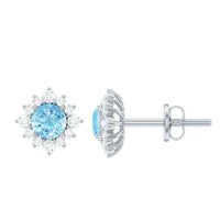 Real aquamarine stud earrings with diamond halo, featuring sparkling gemstones and elegant silver settings.