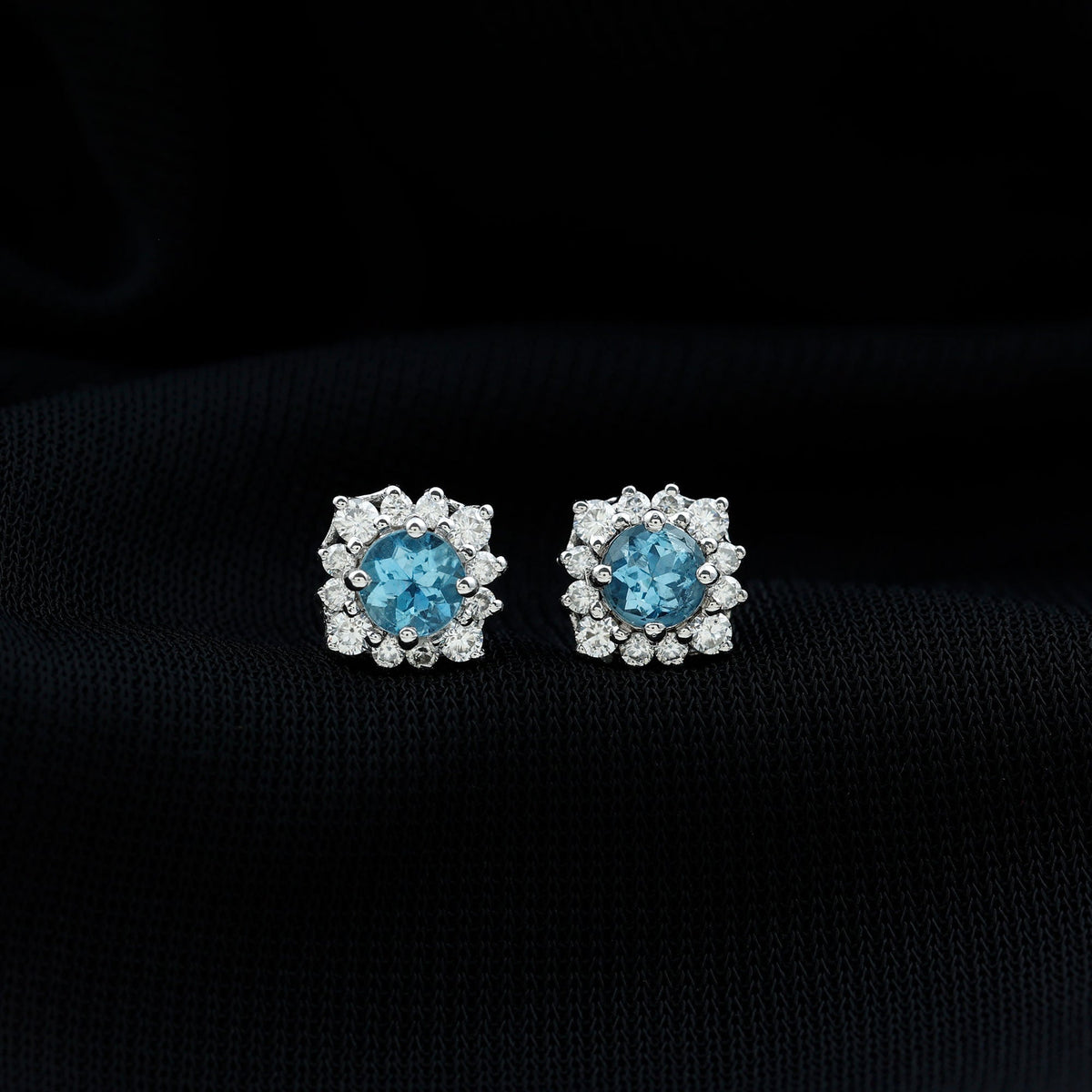 Rosec Jewels real aquamarine stud earrings with diamond halo, showcasing sparkling blue gemstones and elegant jewelry design.