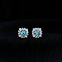 Rosec Jewels real aquamarine stud earrings with diamond halo, showcasing sparkling blue gemstones and elegant jewelry design.