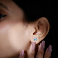 Real aquamarine stud earrings with diamond halo by Rosec Jewels, featuring vibrant blue aquamarine stones and sparkling diamond accents.