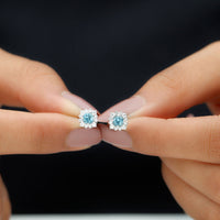 Real aquamarine stud earrings with diamond halo from Rosec Jewels featuring sparkling gemstones and elegant jewelry design.
