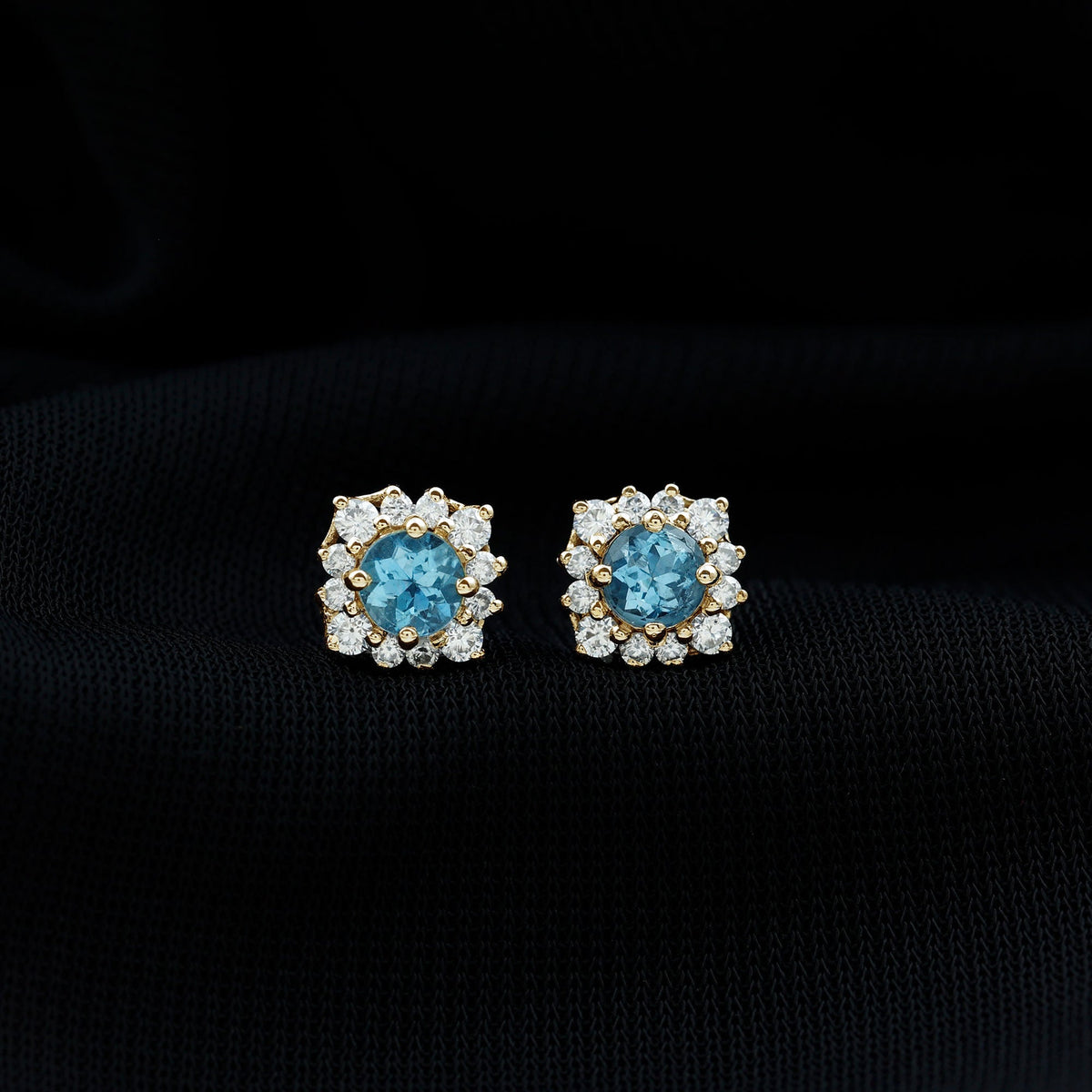 Rosec Jewels real aquamarine stud earrings with diamond halo, showcasing sparkling blue gemstones and elegant design.