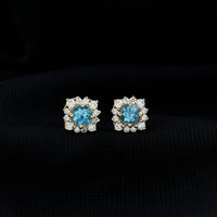 Rosec Jewels real aquamarine stud earrings with diamond halo, showcasing sparkling blue gemstones and elegant design.