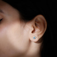 Real aquamarine stud earrings with diamond halo by Rosec Jewels featuring blue gemstones and sparkling diamond accents.