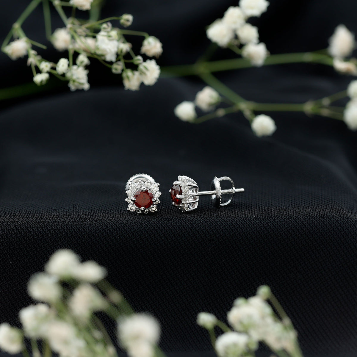 Rosec Jewels 0.6 Carat garnet stud earrings with diamond halo, showcasing classic jewelry design and sparkling gemstone accents.