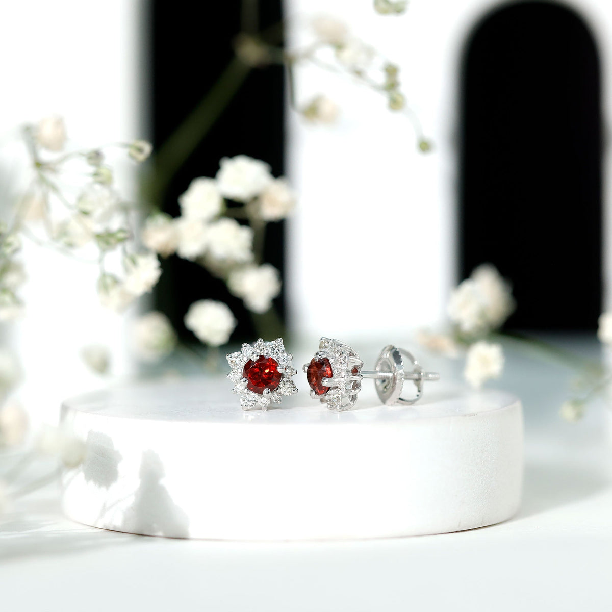 0.6 carat garnet stud earrings with diamond halo by Rosec Jewels, showcasing red garnet stones and sparkling diamond accents.