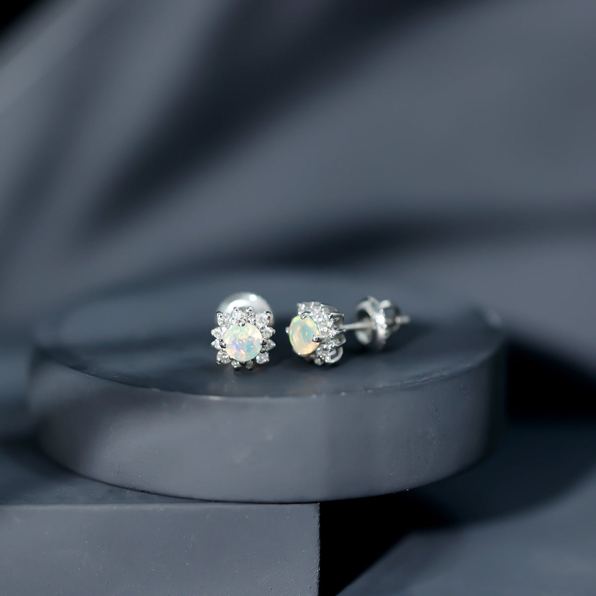 Ethiopian opal stud earrings with diamond halo, Rosec Jewels, featuring vibrant opal stones and sparkling diamond accents.