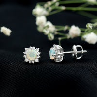 Classic Ethiopian Opal stud earrings with diamond halo from Rosec Jewels, featuring vibrant opal gemstones and sparkling diamond accents.