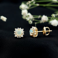 Ethiopian opal stud earrings with diamond halo by Rosec Jewels, featuring vibrant opal stones surrounded by sparkling diamonds.