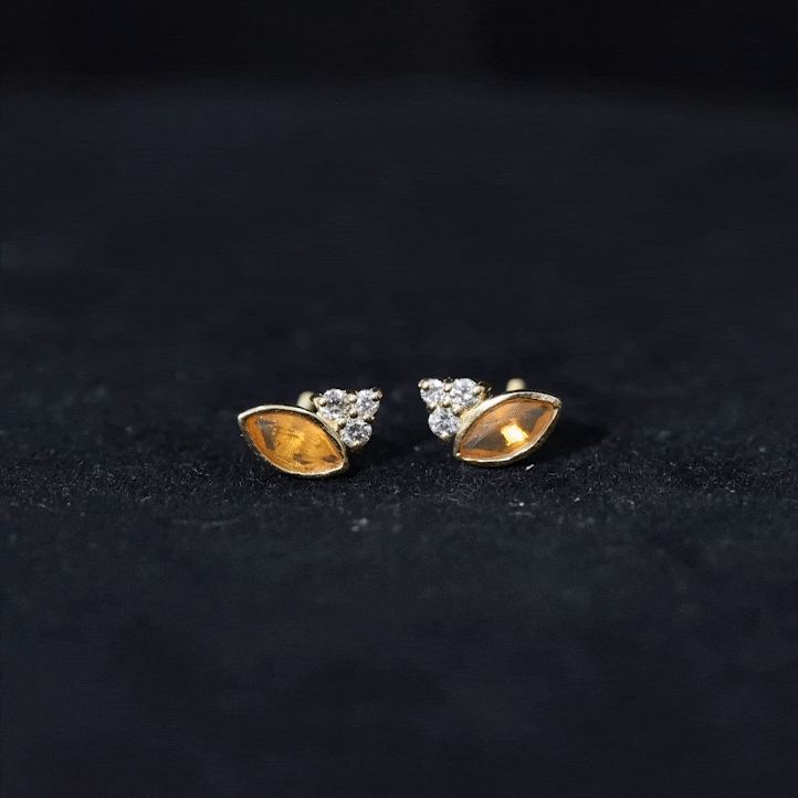 Marquise cut fire opal stud earrings with diamond trio accents by Rosec Jewels, showcasing vibrant orange gemstones and sparkling diamonds.