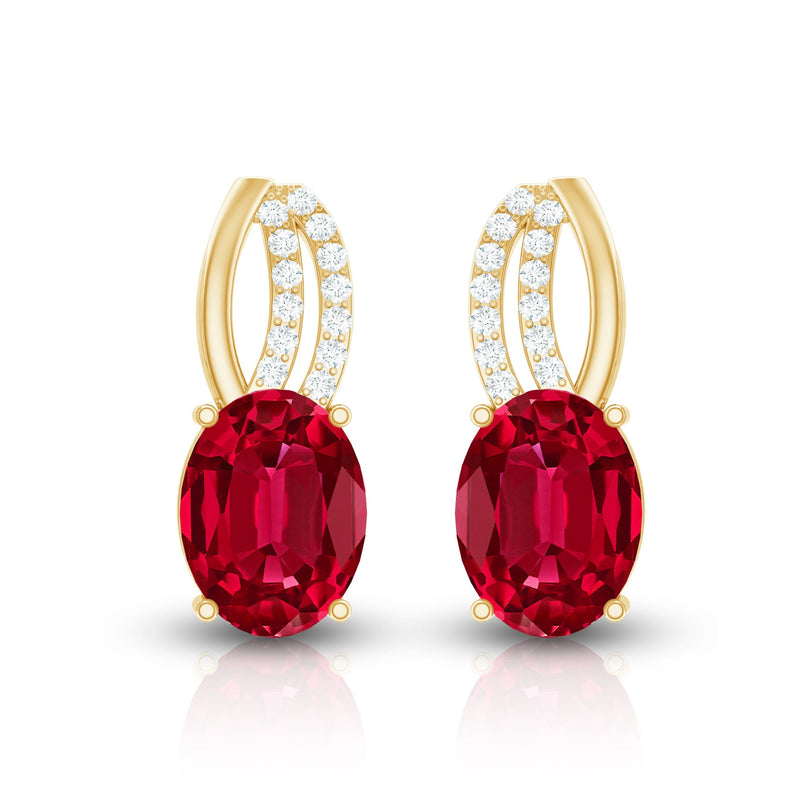 Oval lab-created ruby stud earrings with diamond accents by Rosec Jewels, featuring sparkling gemstones and elegant design.